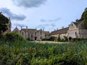A grand country estate with greenery in the foreground