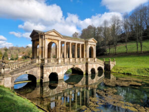 Ornate Palladian bridge over a still lake