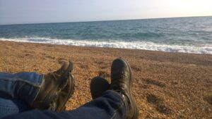 Dorset coast walking holiday - image of walking boots on the beach