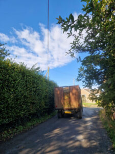 Back of a tractor trailer full of apples on a country lane