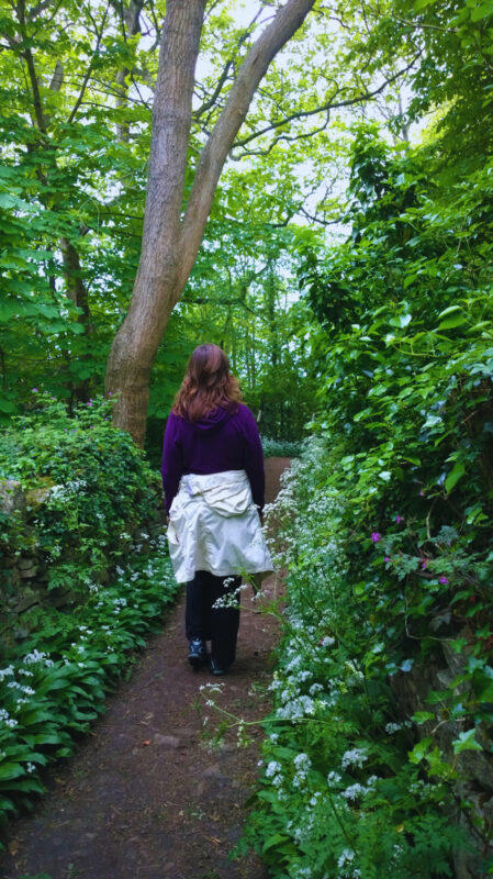 Alison walking in the woods in spring