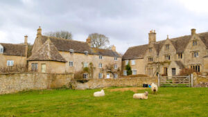 Cotswold stone cottages with sheep in the foreground