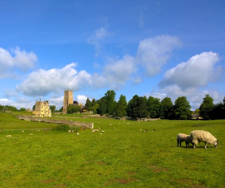 Grand Cotswolds church with grazing sheep in foreground