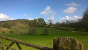 Gate and view on rolling Cotswolds countryside