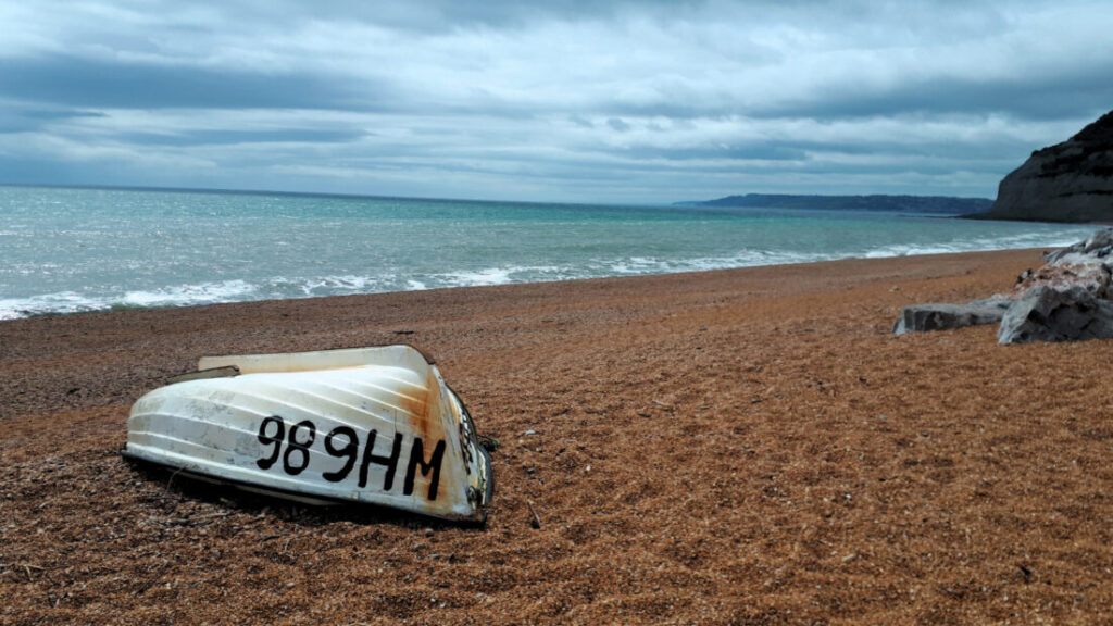 Upturned boat on a shingle beach in Dorset