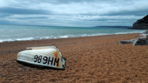 Upturned boat on a shingle beach in Dorset