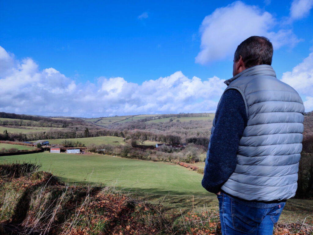 Walker looking out over a valley in Exmoor