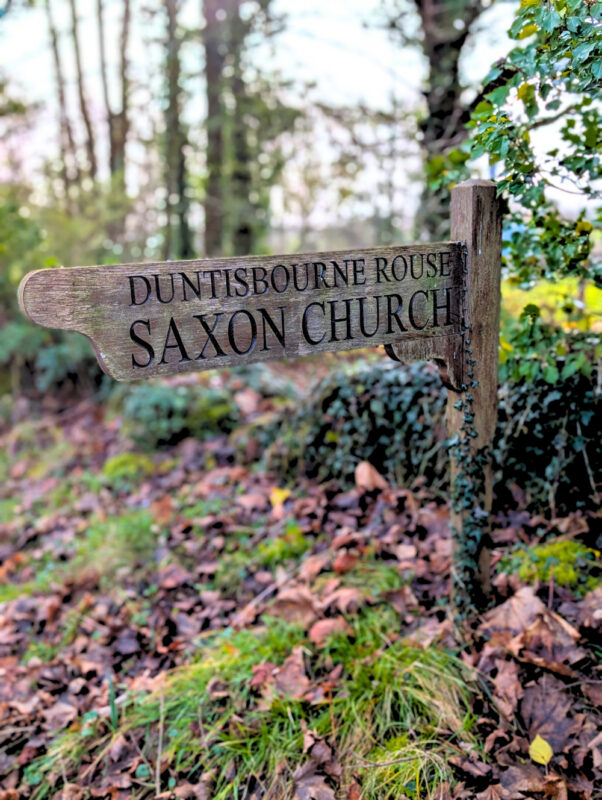 Signpost to church in woodlands