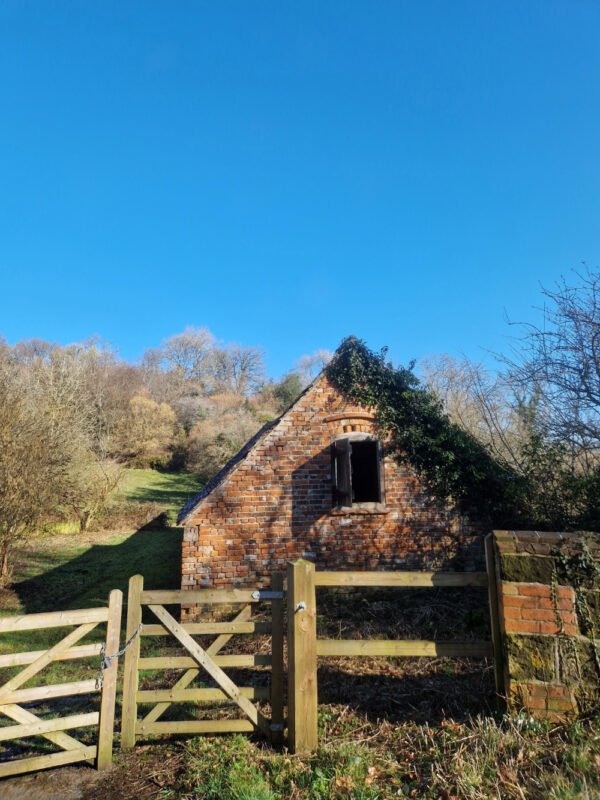 Old brick barn and gate in the countryside