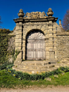 An ornate wood and stone gate