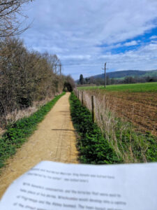 A piece of paper with writing on it blurred out with a path stretching off into the distance