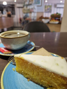 A photo of a slice of cake and a cup of coffee