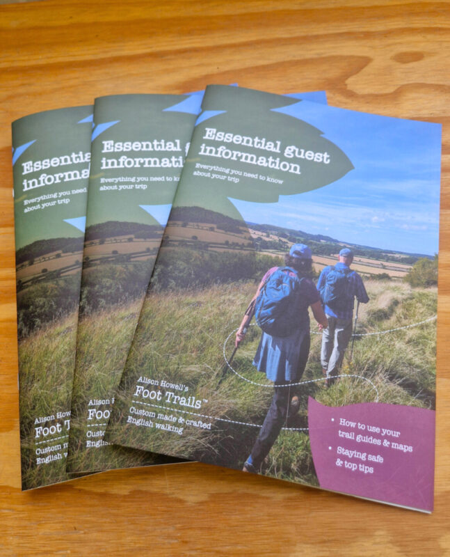 Photos of three copies of Foot Trails' new guest information brochure