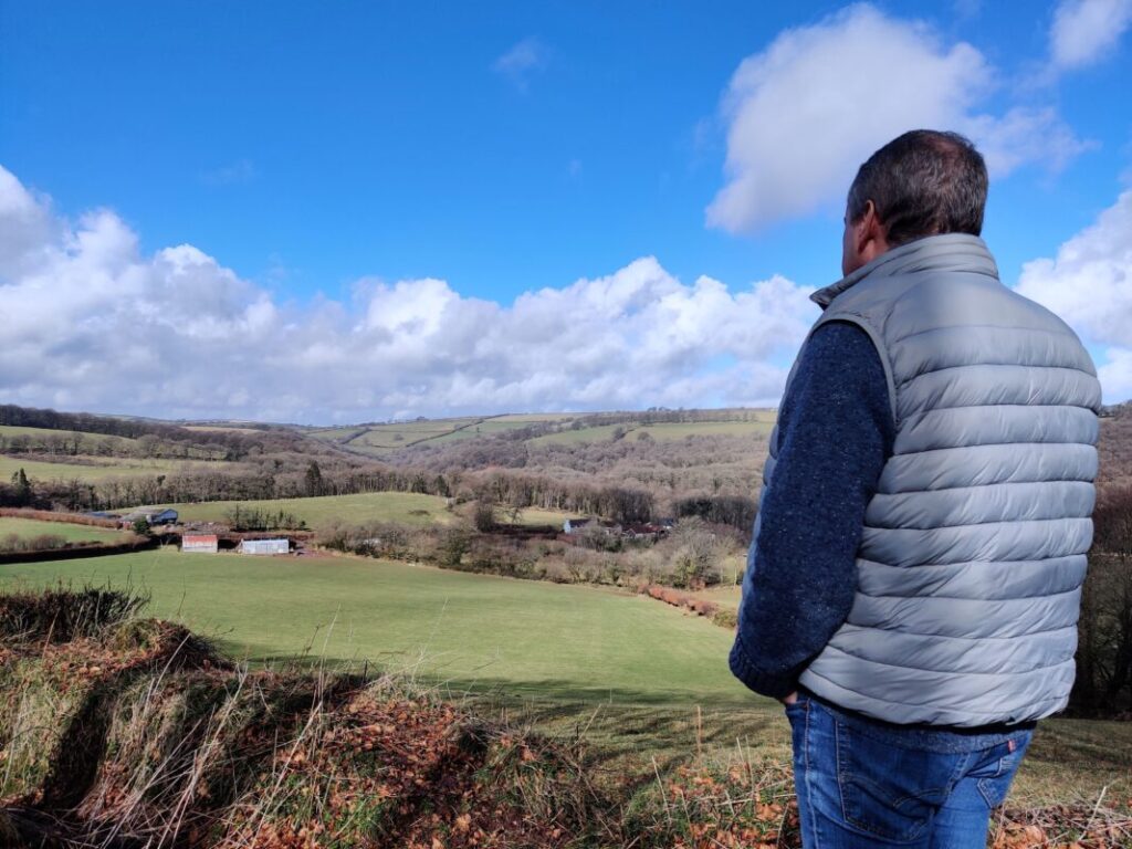 Photo of a person looking out over the Exmoor landscape