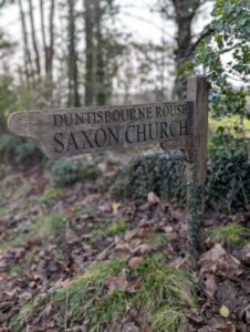 A wooden finger post pointing the way to a Saxon church