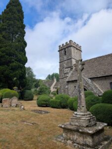 An old church with a monument in the foreground