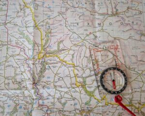 An OS map of Exmoor with a compass resting on top