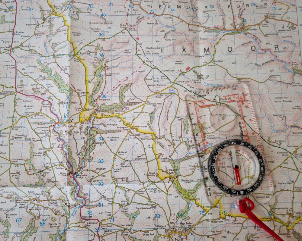 An OS map of Exmoor with a compass resting on top