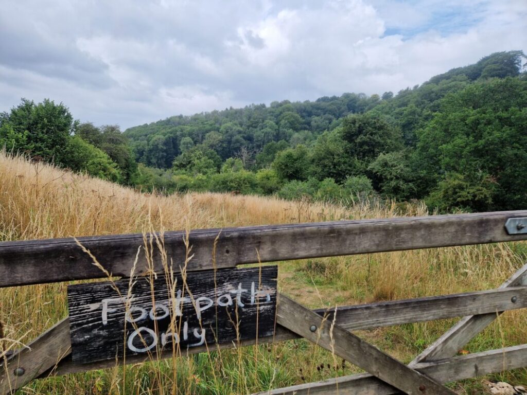 Wooden gate with a hand-painted sign saying 'Footpath only'