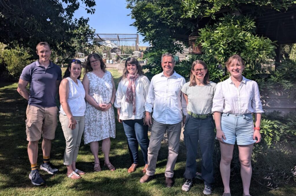 Photo showing the Foot Trails team standing in garden surrounded by trees