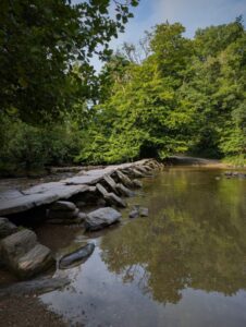 View of a medieval stone clapper bridge over a river