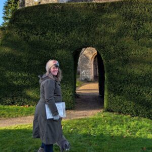 Picture of Foot Trails Founder Alison in front of a hedge