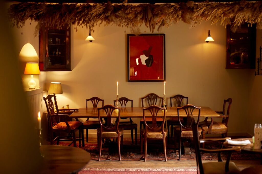 Photo of a atmospheric dining room, with soft lights and candles.
