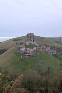 A ruined castle on a hill in an autumnal setting