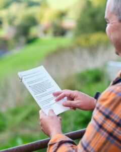 Photo of a person holding a Foot Trails trail guide and pointing to something in the guide.