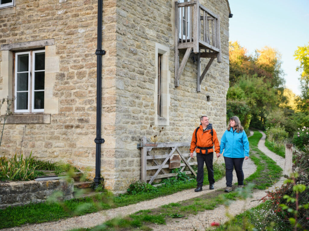 Two people hike in the Cotswolds, England