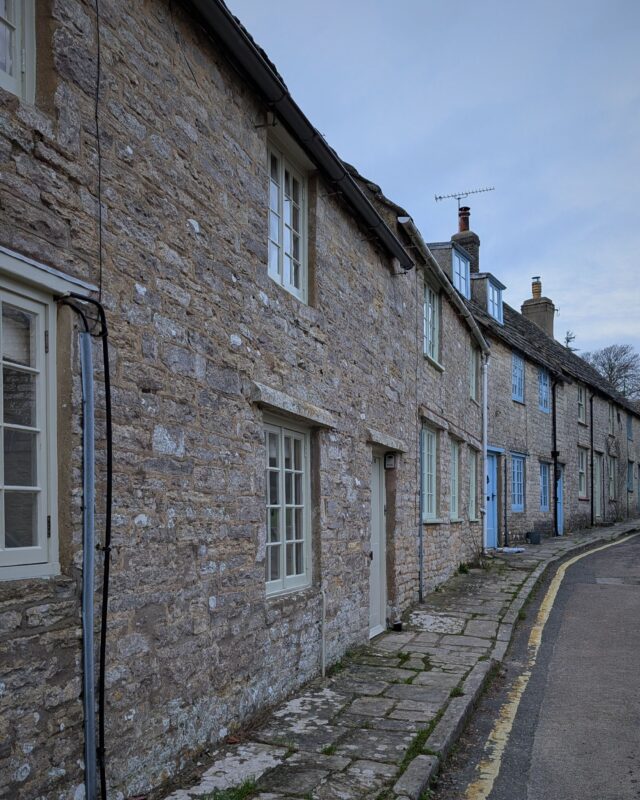 A row of old stone cottages in a coastal village in Dorset.
