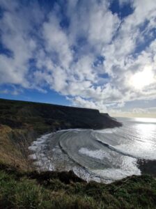 View looking down on a secluded cover in winter from sea cliffs.