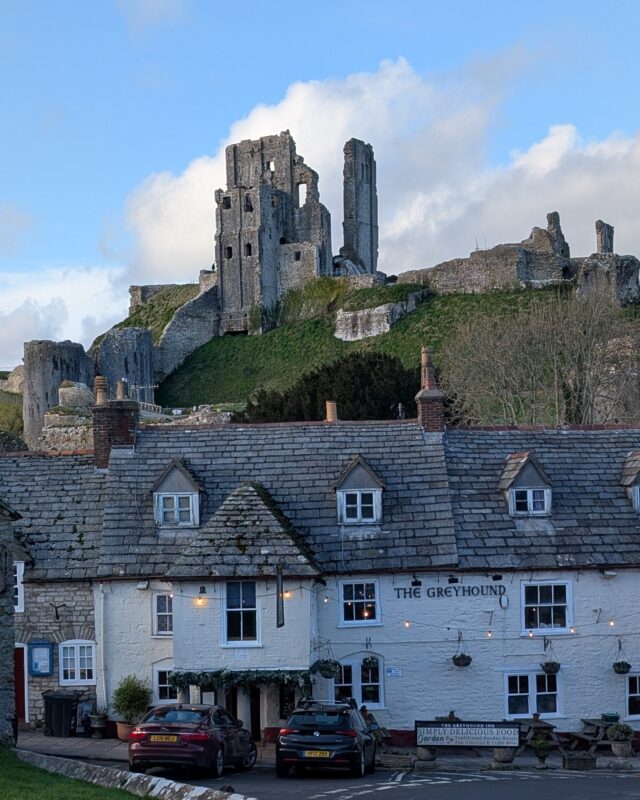 View of an 11th century castle ruin towering over a village inn.