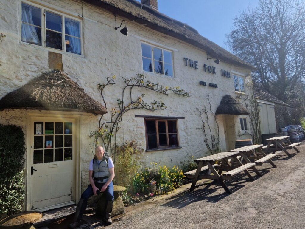 Image of Foot Trails Co-Founder David resting in front of an traditional country inn.