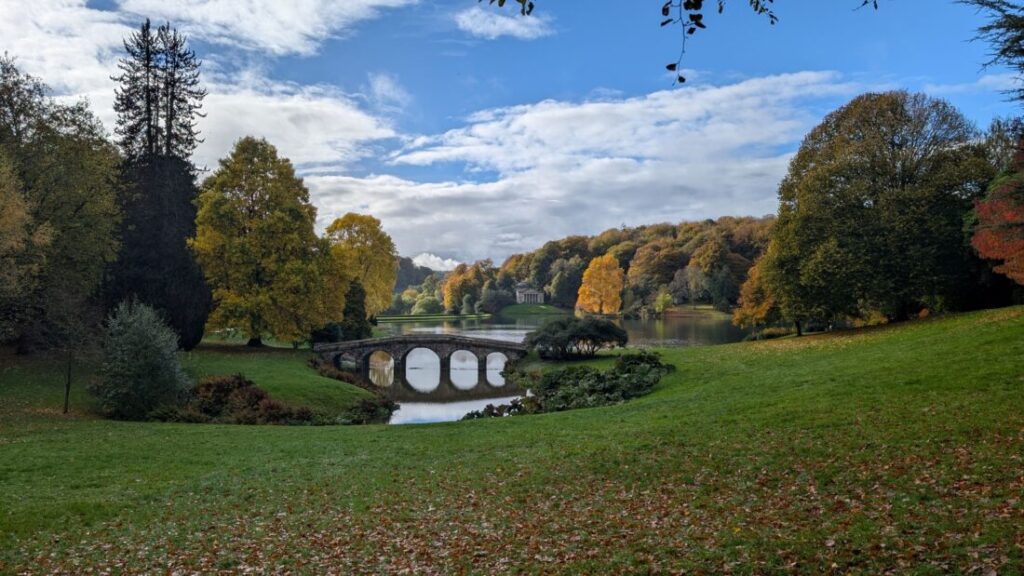 View of Stourhead gardens and an ornamental bridge over the lake.