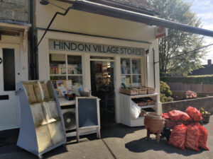 A traditional village shop with produce on display outside the shop.