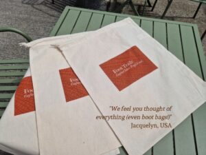 Phot of three linen boot bags with the Foot Trails logo and branding on the front.