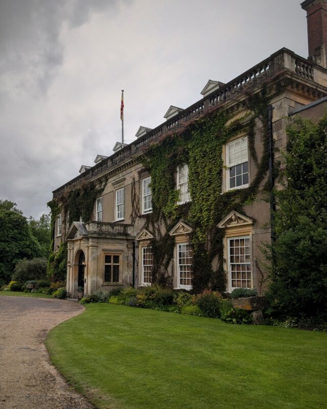 Photo of a grand country house from the driveway.