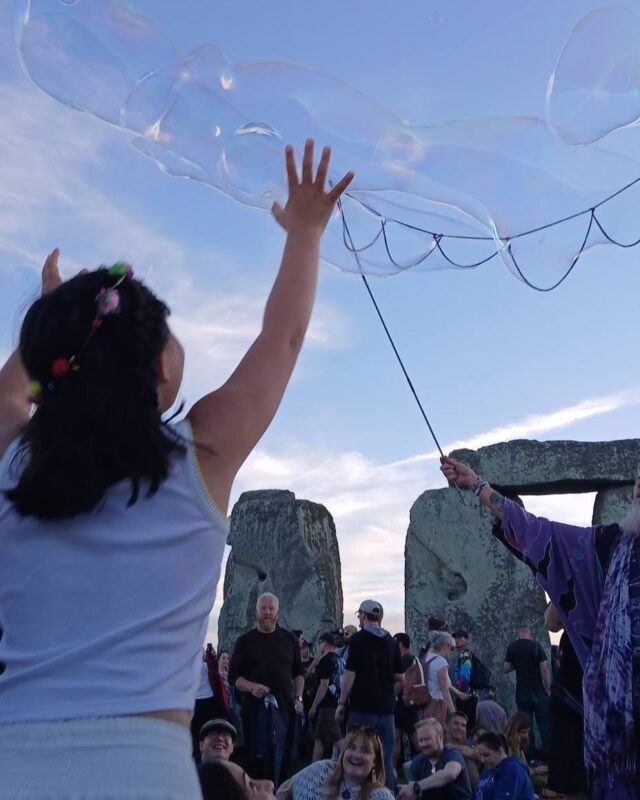 Photo of crowds gathered at Stonehenge to welcome the sunrise on the summer solstice