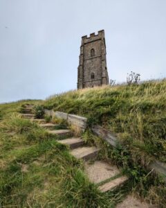 View of Glastonbury Tor from the steps leading up to the church tower.