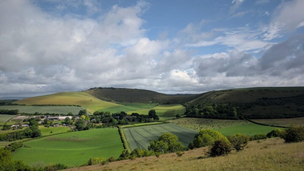 View over farmland to a chalk escarpment.