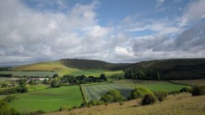View over farmland to a chalk escarpment.