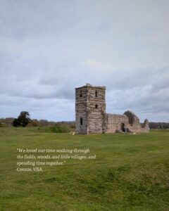 Ancient church ruins sit in the middle of a Neothlic henge with green fields stretching off into the horizon.