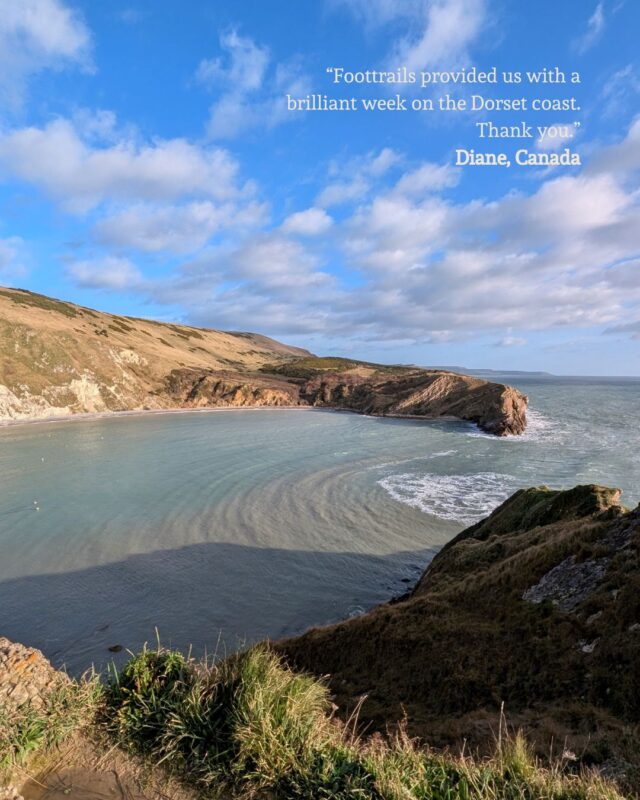 Image of Lulworth Cove on a sunny day with a guest quote superimposed over the blue sky: “Foottrails provided us with a brilliant week on the Dorset coast. Thank you.” Diane, Canada